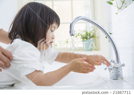 A 2 year old girl washing his hands A 2 year old girl washing his hands 21867711