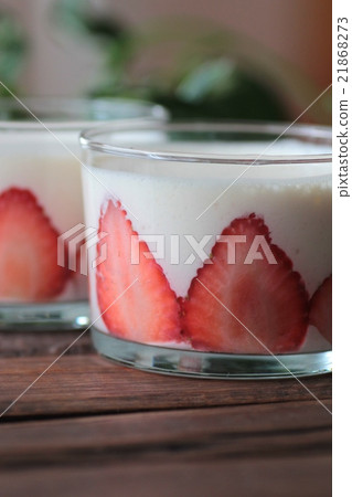 Strawberry yogurt jelly in a glass cup with green leaves 21868273