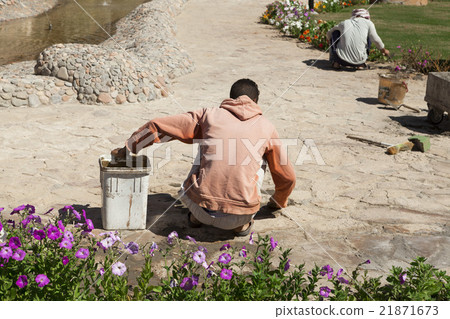 The builder, gardener is working on repair tracks The builder, gardener is working on repair tracks 21871673