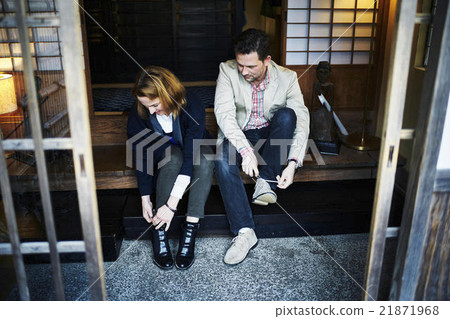 Foreigners wearing shoes at the entrance Foreigners wearing shoes at the entrance 21871968