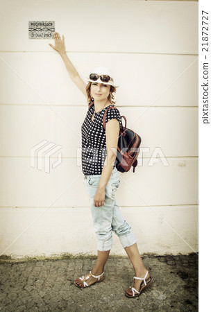 Young tourist woman is showing memory plaque of flood in Passau, 21872727