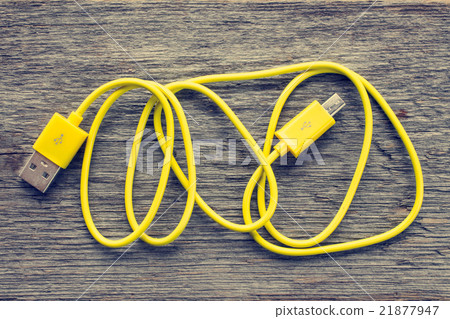 Yellow USB cable on wooden table 21877947