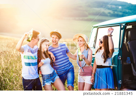 Group of teenage hipsters on a roadtrip, drinking 21881345
