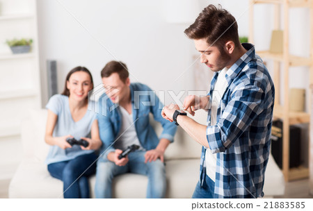 Pleasant guy looking at his wrist watch 21883585