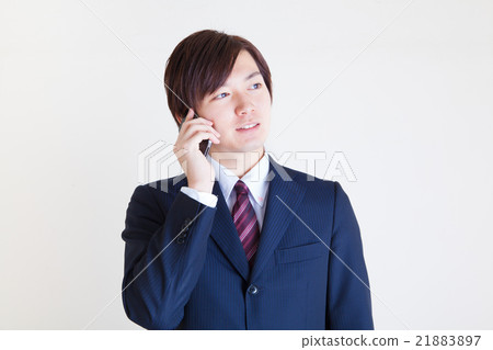 Male wearing a suit Calling on a smartphone 21883897