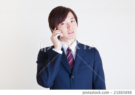 Male wearing a suit Calling on a smartphone 21883898