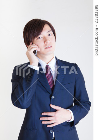 Male wearing a suit Calling on a smartphone 21883899