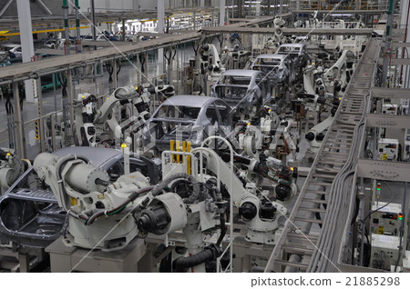 Welding line of automobile factory where industrial robots line up 21885298