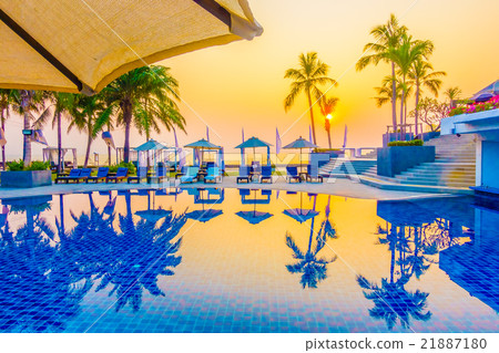 Beautiful Silhouette palm tree with umbrella and chair Beautiful Silhouette palm tree with umbrella and chair 21887180