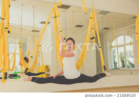 Girl doing splits with trx fitness straps Girl doing splits with trx fitness straps 21889520