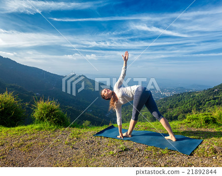 Woman doing Ashtanga Vinyasa yoga asana Parivrtta 21892844