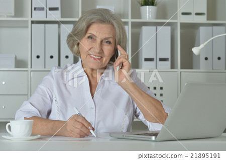 Elderly woman working on laptop Elderly woman working on laptop 21895191