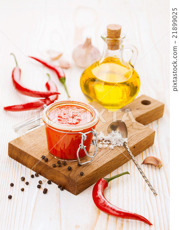 Jar of piquant sauce made from chili peppers and 21899025