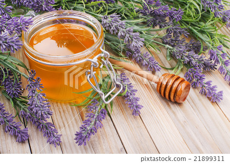 jar of liquid honey with lavender 21899311
