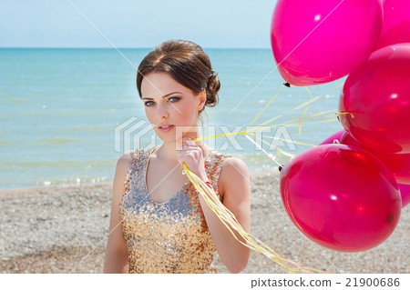woman with balloons on the sea 21900686