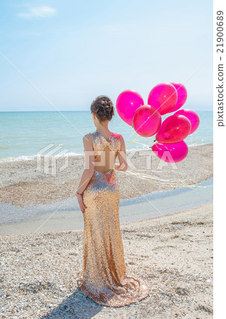 woman with balloons on the sea 21900689