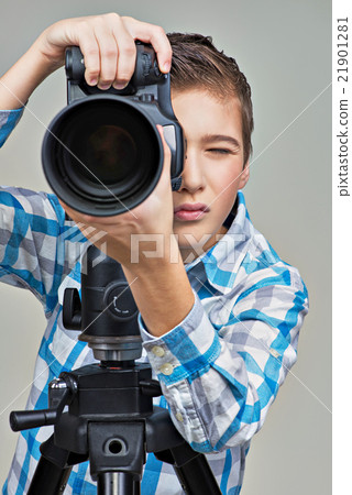 Boy with camera taking pictures 21901281