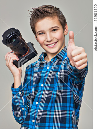 Boy with camera taking pictures. Boy with camera taking pictures. 21901300