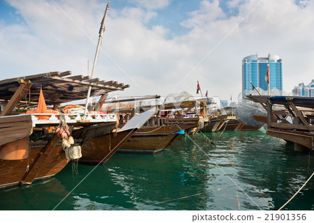 Abu Dhabi buildings skyline with old fishing boats Abu Dhabi buildings skyline with old fishing boats 21901356
