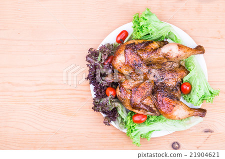 Juicy grilled roast chicken with salad garnish 21904621