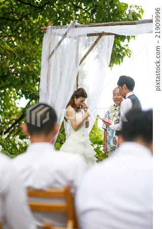 Bride and groom performing a wedding ceremony Bride and groom performing a wedding ceremony 21909996