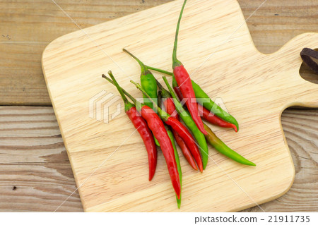 Chili on wooden plate 21911735