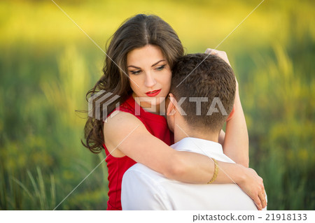 Happy young couple embrace in park Happy young couple embrace in park 21918133