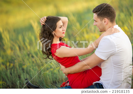 Happy young couple embrace in park Happy young couple embrace in park 21918135