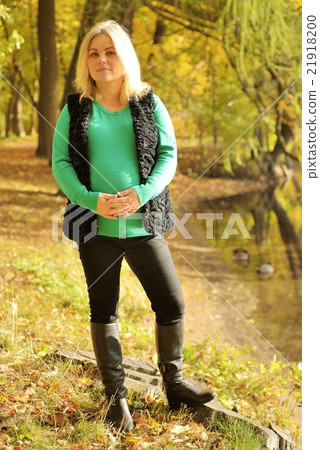 Pregnant woman posing in autumn park 21918200