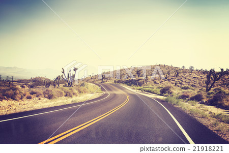 Vintage toned desert road seen through windshield. 21918221