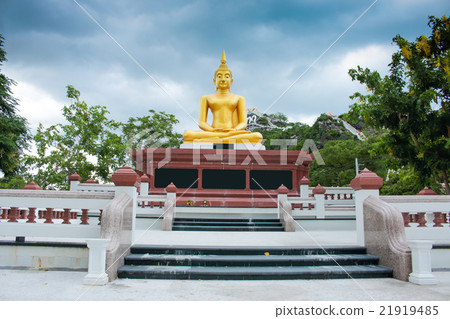 Buddha statues on blue sky before rain front view Buddha statues on blue sky before rain front view 21919485