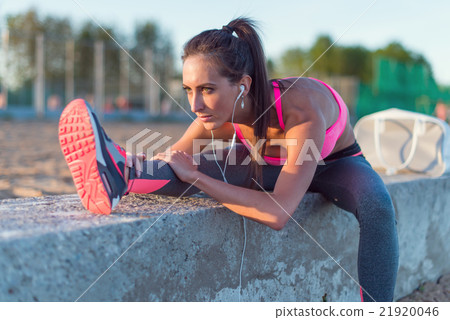 Athletic woman stretching her hamstring, legs 21920046