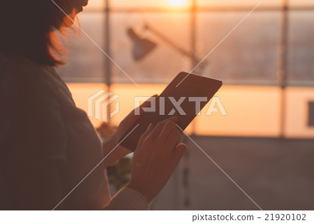 Rear view picture of female hands holding tablet Rear view picture of female hands holding tablet 21920102