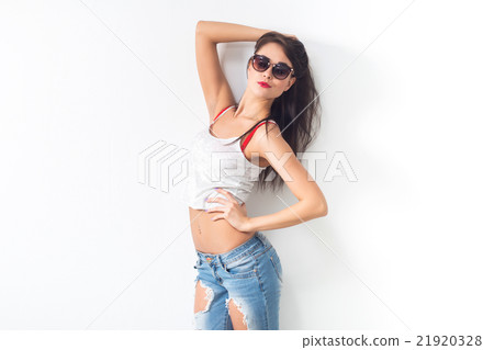 Beautiful woman posing in studio, presenting new 21920328