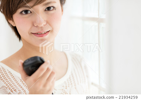 A woman carrying a radio A woman carrying a radio 21934259