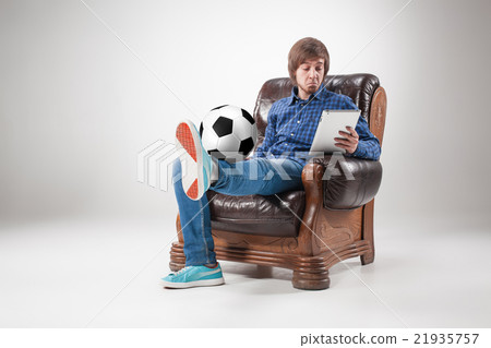 Portrait of young man with laptop and football 21935757