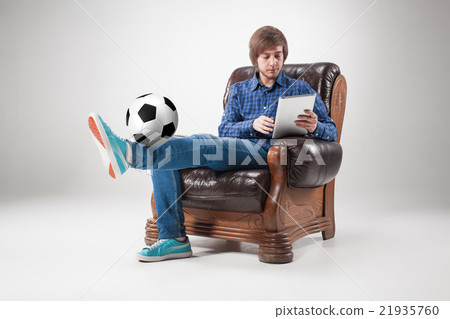 Portrait of young man with laptop and football Portrait of young man with laptop and football 21935760