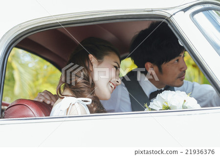 Bride and groom riding a wedding car Bride and groom riding a wedding car 21936376