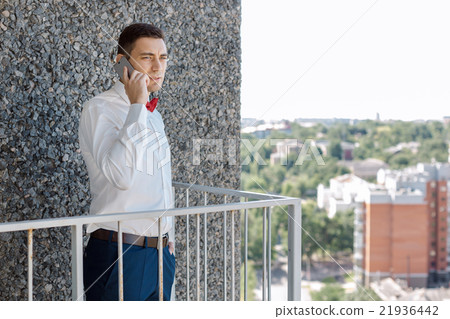 Serious Groom talking by phone 21936442