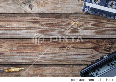Cassette tape, cassette player and headphones over Cassette tape, cassette player and headphones over 21941003
