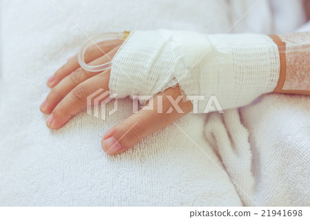 Saline intravenous drip in child's patient hand. Saline intravenous drip in child's patient hand. 21941698