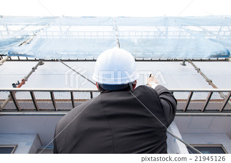 A man with a helmet to check the building 21945126