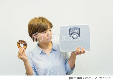 A woman with a scale and a donut A woman with a scale and a donut 21945886