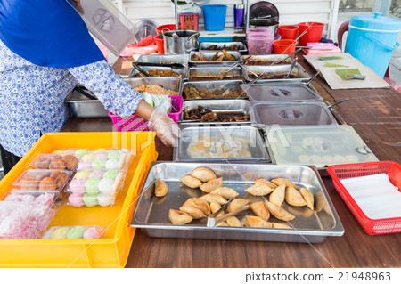 Vendor selling Malay sweet cakes food at stall Vendor selling Malay sweet cakes food at stall 21948963