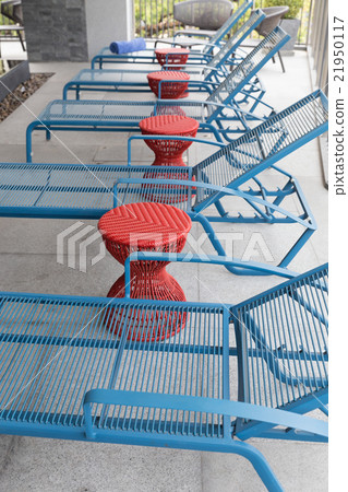 blue bed beside swimming pool 21950117