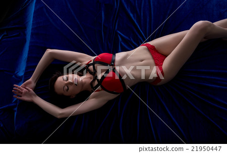 Top view of woman in lingerie and sword belt lying Top view of woman in lingerie and sword belt lying 21950447