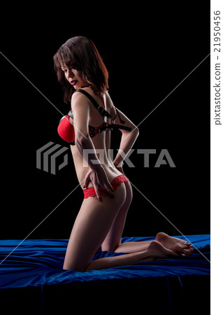 Image of hot brunette posing on her knees in bed Image of hot brunette posing on her knees in bed 21950456