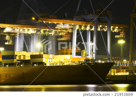 Large container ship in a busy dock at night 21951609