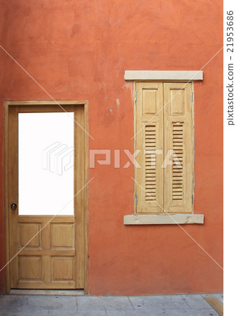 wooden door and window in an orange wall 21953686