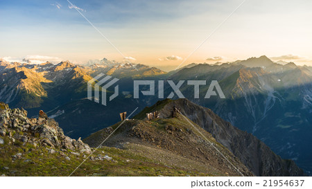 Warm light at sunrise on mountain peaks, ridges and valleys 21954637